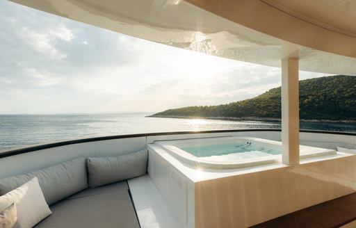 On deck Jacuzzi with surrounding sun pads onboard charter yacht AGAPE ROSE
