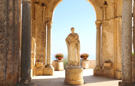 statue in gardens of ravello below archway