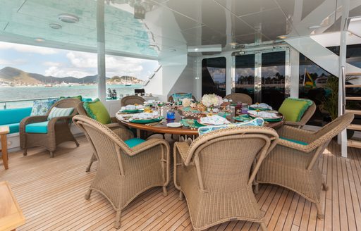 The central alfresco dining space featured on board motor yacht ATTITUDE