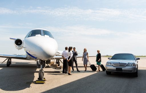 a welthy couple board a private jet to their target destination where they will board their luxury charter yacht 