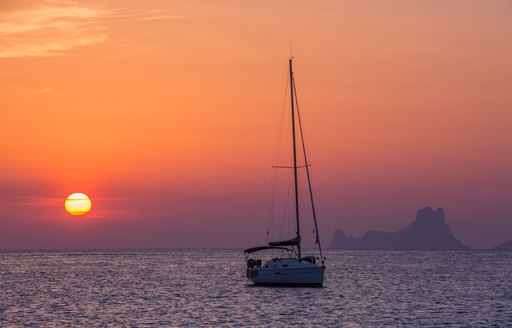 Sailing yacht cruising at sunset Ibiza