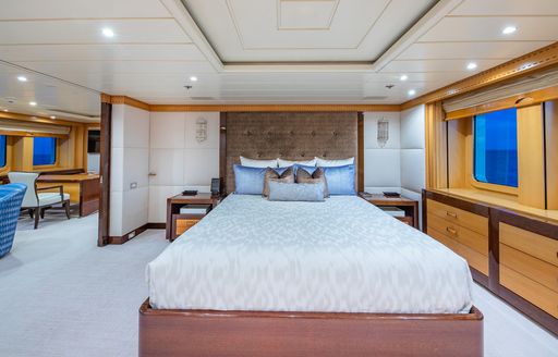 Master cabin onboard charter yacht NITA K II, central berth facing forward with lounge area to port.