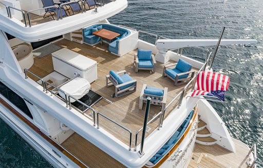 Overview of the aft decks onboard charter yacht ALMOST THERE with blue seating arranged to face inwards