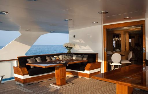 Shaded al fresco dining and relaxing space on board charter yacht Shake N Bake