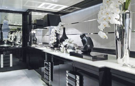 View of flowers and sculptures on counter top on superyacht Silver Angel