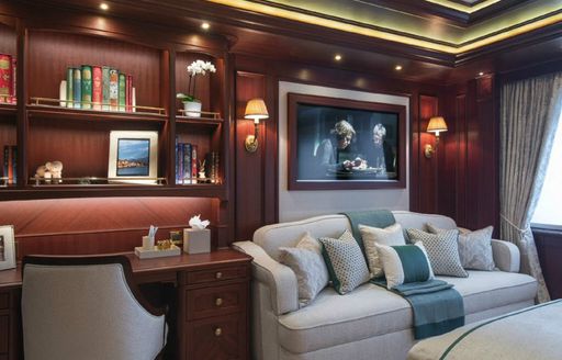 Main salon aboard luxury yacht ARETI with mahogany furnishings