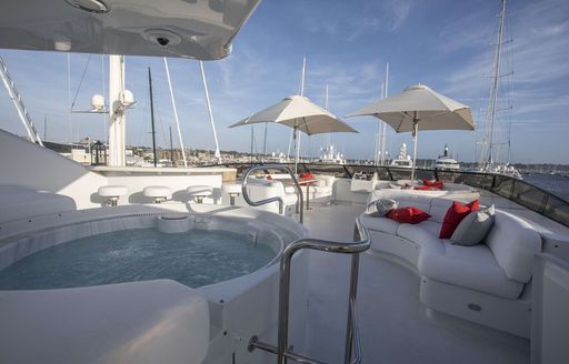 Sundeck on board superyacht INVISION, with seating areas and hottub 