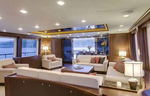 lounge area of main salon with view onto aft deck aboard luxury yacht Masteka 2