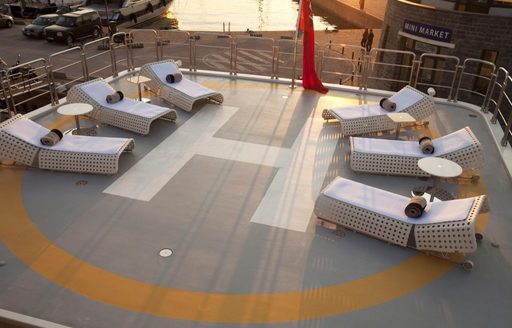 Helipad and sunbeds onboard luxury superyacht charter boat