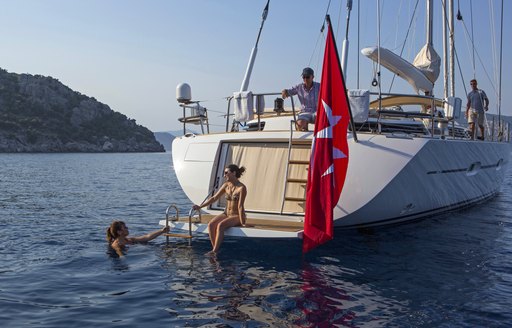Two female charter guests on swimming platform of sailing yacht Savarona