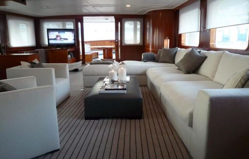 sofa and armchairs in the classic-styled main salon aboard luxury yacht Secret Life 