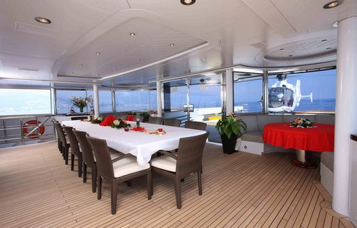 Exterior dining area onboard charter yacht NOMAD