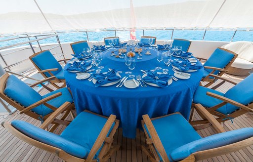 Dining table with blue tablecloth on board superyacht Duke Town