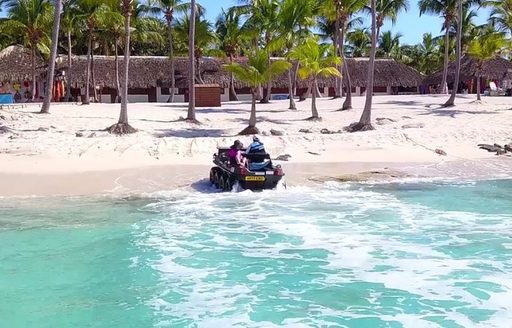 All-terrain amphibious vehicle approaching land while away from charter yacht MIRAGGIO