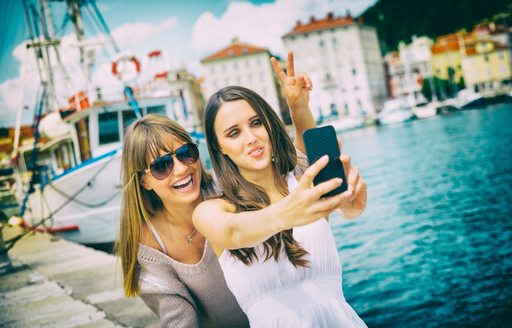 friends taking selfies on a italian riviera luxury yacht charter vacation in cinque terre