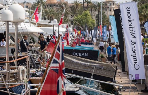 yachts lined up along the boardwalk with brokers' bunting at the Palma Superyacht Show 2018