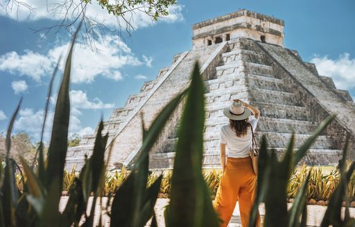 woman looking at a pyramid in Mexico