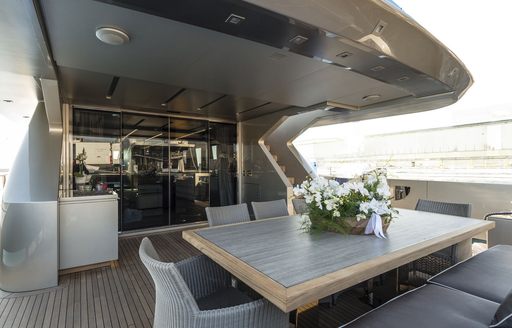 A small table and chairs on the sundeck of superyacht SHADOW