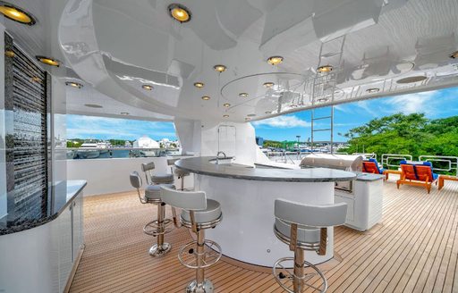 Overview of an exterior wet bar with stools onboard charter yacht VALHALLA