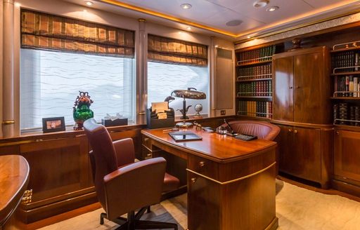 Office area with desk and leather chairs onboard charter yacht OLYMPUS