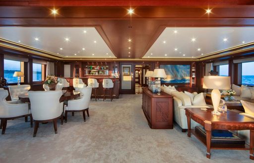 Upper salon lounge seating onboard private charter yacht GIGIA, surrounded by large windows