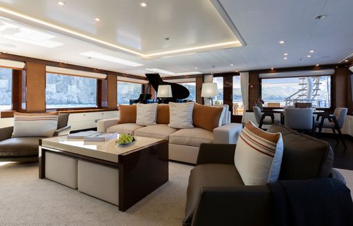 Interiors onboard charter yacht GALENE, lounge area in the foreground with a grand piano aft