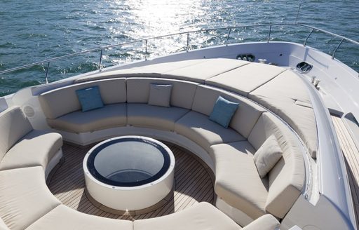 Elevated view looking down on the foredeck of charter yacht 55 FIFTYFIVE, circular plush seating with sweeping panoramic views
