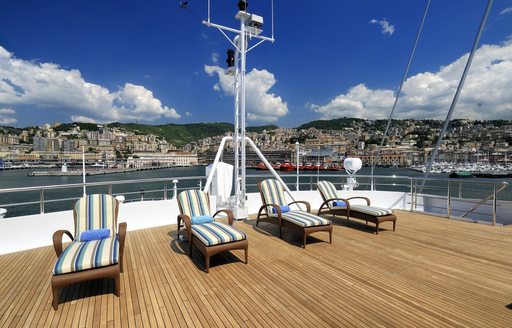 chaise loungers line up on sundeck of luxury yacht ‘Lauren L’ 