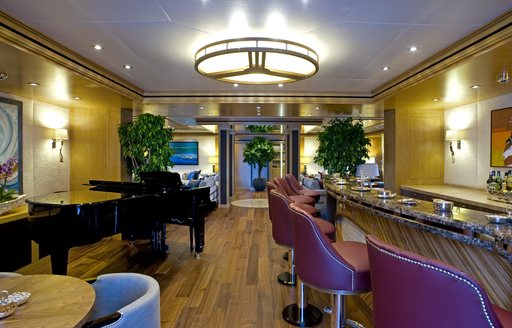bar and grand piano in main entrance on main deck of superyacht ‘Indian Empress’ 