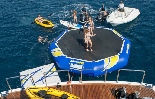 charter guests enjoy water trampoline and other water toys on board motor yacht AUSTRALIS 