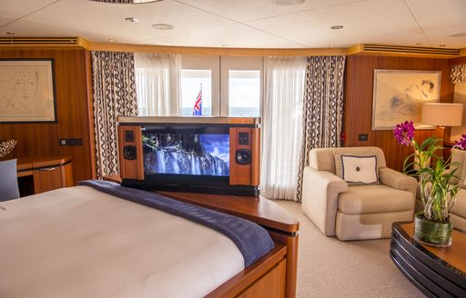 master suite with pop-up TV and private deck area on board charter yacht SPIRIT