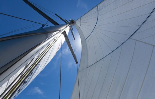 Close up of a hoisted sail attached to a spreader