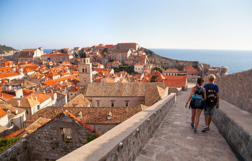People walking along the ramparts of the city walls in Dubrovnik's Old Town, Croatia