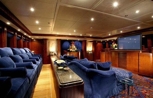 Interior cinema onboard charter yacht NOMAD with plush blue seating