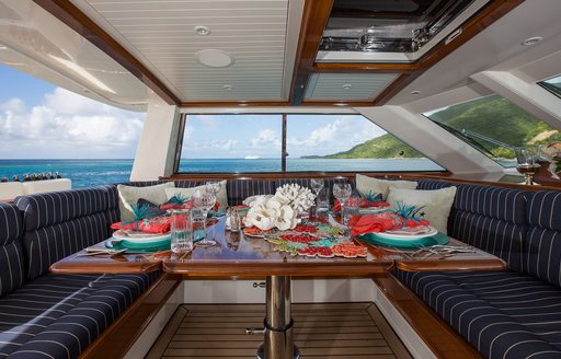 table set for alfresco dining in pilothouse of charter yacht MARAE 