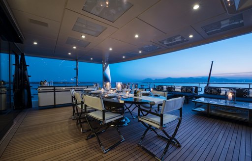 luxe alfresco dining area aboard superyacht ELIXIR as the sun sets over the horizon