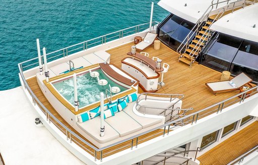 Aerial view of the aft deck onboard charter yacht AXIOMA, pool with swim up bar visible along with sunloungers 