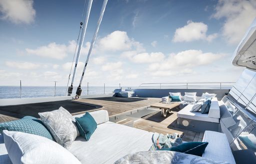 Exterior lounge area onboard S/Y GREY B, with ample seating around the deck and surrounding views of the sea.