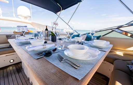 Sundeck dining area onboard charter yacht CHESS