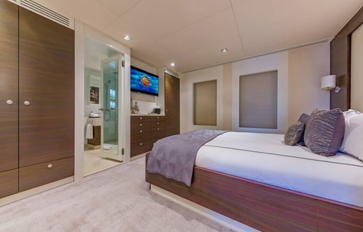 Guest cabin onboard charter yacht BIG SKY, central berth facing port opposite access to a private en-suite