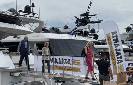 Brokers and yachting professionals stepping off superyacht at the Mediterranean Yacht Show
