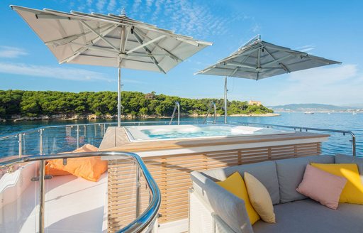 Jacuzzi shaded by parasols on the sundeck of charter yacht DYNAR 