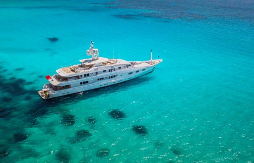 Luxury charter yacht at anchor in the cruising grounds of Spain, aerial shot