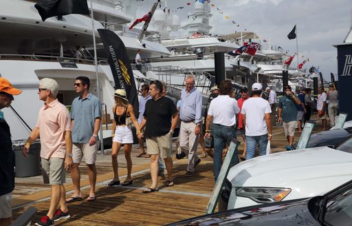 visitors stroll the boardwalks at FLIBS looking at the superyachts