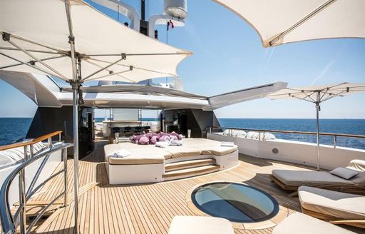 benetti motor yacht st david sun deck with sun pads and umbrellas