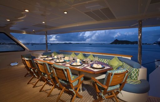 luxury motor yacht ATLANTICA al fresco dining table with spectacular views of the Bahamas 