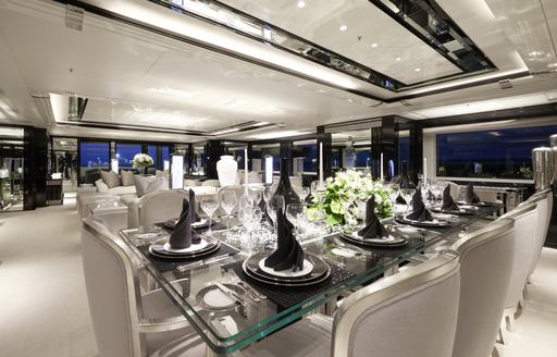 Overview of the main salon onboard charter yacht SILVER ANGEL, dining area in foreground with lounge aft