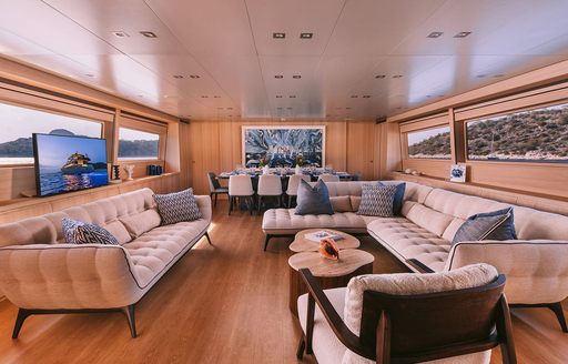 Main salon lounge onboard charter yacht ISLANDER II, spacious seating area with rectangular windows to starboard