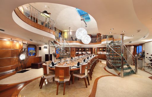 The large dining table featured in the interior of superyacht SHERAKHAN