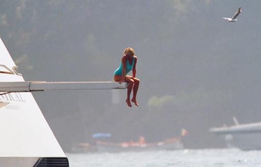 Diana perched on edge of a diving board on board yacht BASH (ex-Jonikal) in 1997